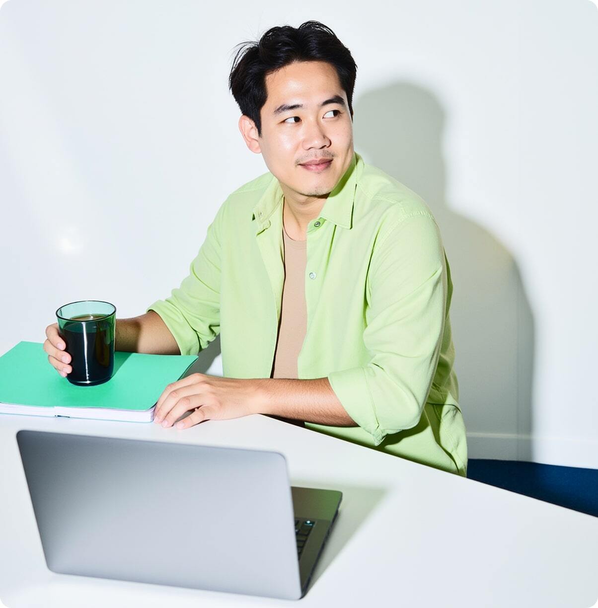 A man is sitting at a desk with a laptop